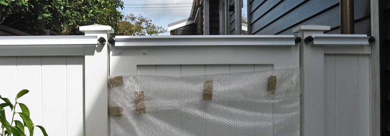 Oscillot system in Arctic White on a beautiful new fence and gate