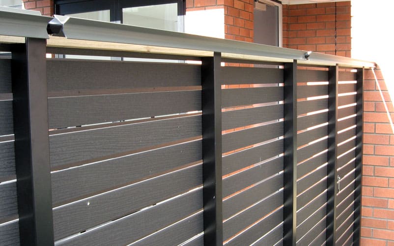 Oscillot paddles attached to aluminium fence posts, with timber behind to close the cap.