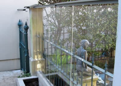 Clear acrylic was used to raise the height of this fence while still allowing natural light into the courtyard.