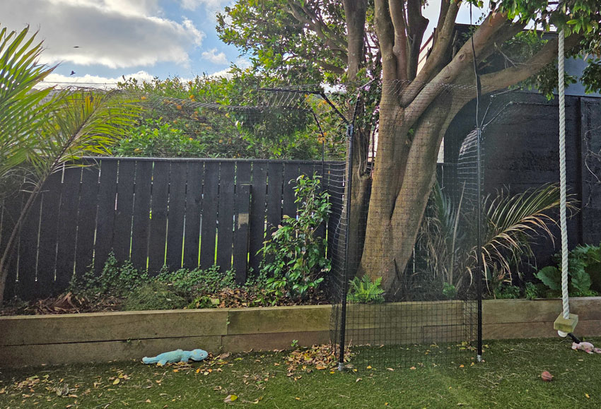 Purrfect Fence freestanding system used to around a tree